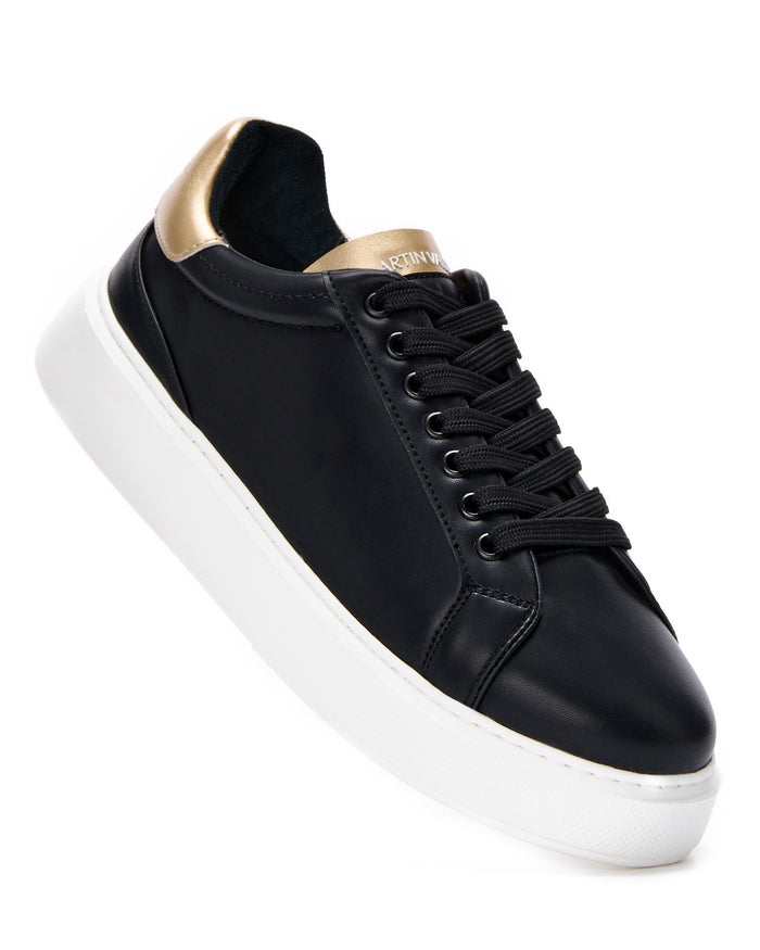 Martin Valen Iconic men's black-gold sneaker, angled close-up showing black laces, gold heel tab and white platform sole