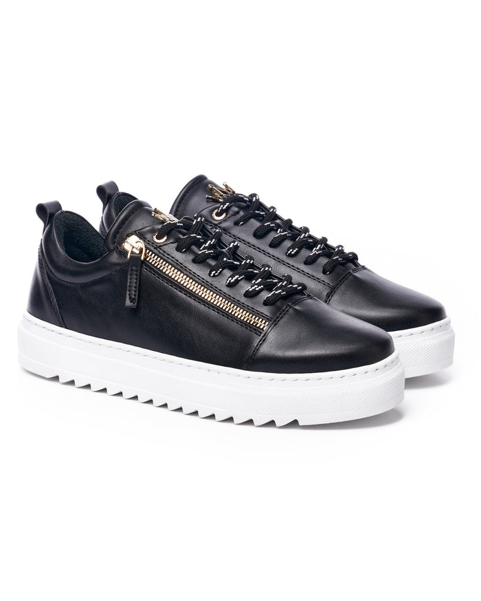 Martin Valen pair of black low-top sneakers three-quarter view with contrast laces and visible gold zipper