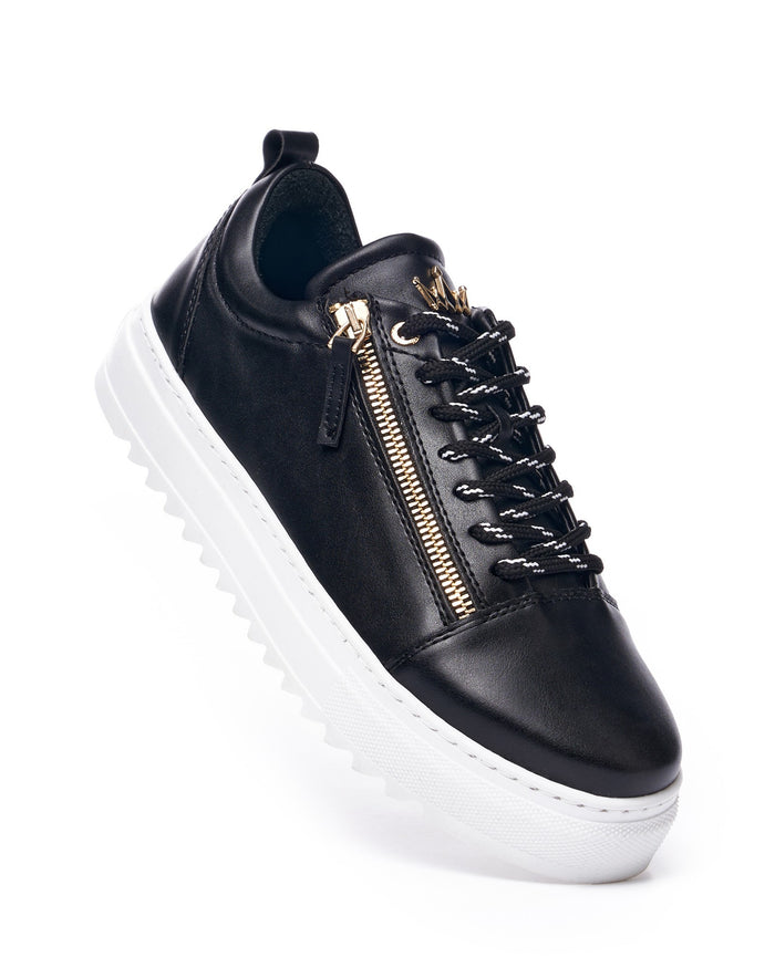 Martin Valen men's low-top black sneaker, side close-up showing gold zipper detail and white ridged sole